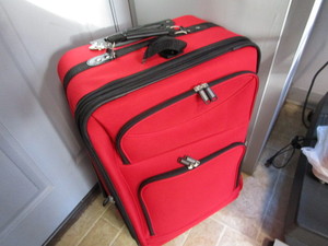 New suitcase, 22x16x11 with roll...