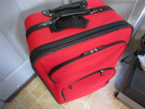 New suitcase, 27x16x11 with roll...