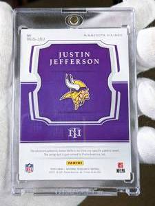 lot 100 image: Justin Jefferson National Treasures 11 Autographed Nike Swoosh Football Rookie Card