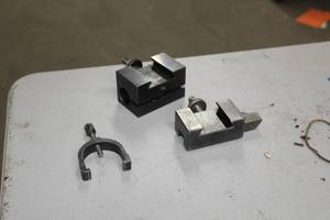 lot 254 image: Lot of (3) Vee Block Accessories  - Vee Block Mounts (x2), Vee Block Clamp (x1)