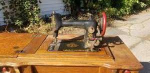 lot 87 image: Antique Golden Rule B Sewing Machine and Cabinet