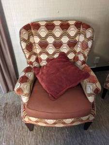 lot 58 image: Upholstered Wingback Chair with Geometric Design and Coordinating Throw Pillow