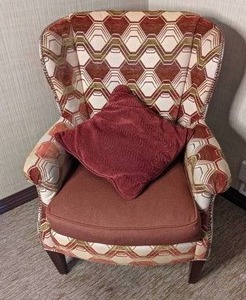 lot 59 image: Upholstered Wingback Chair with Geometric Design and Coordinating Throw Pillow