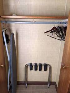 lot 90 image: Contents of Closet Luggage Rack, Hangers and Ironing Board