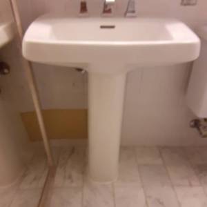 lot 1053 image: Tall White Pedestal Sink