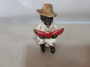 lot 12 image: Americana Boy Eating Watermelon Cast Iron Coin Bank 5 Tall