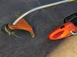 lot 135 image: Stihl Gas Powered Weed Trimmer with a Black & Decker Electric Hedge Trimmer