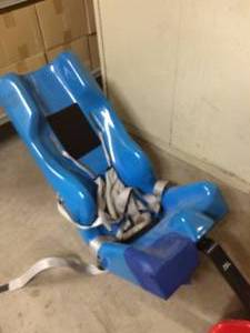 lot 9 image: MSRP $1500 TUMBLE FORMS JUNIOR CARRIE SEAT WITH RED FOOT RESTS - GREAT CONDITION 1ST PIC IS A STOCK PIC REST ARE ACTUAL ITEM