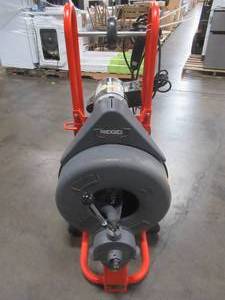 lot 10 image: RIDGID 115-Volt K-750 AUTOFEED Drain Cleaner Machine with 34 in. Pigtail - Works Bulb has a small tear in it, Missing Cutters.