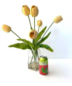 Glass vase of realistic artificial tulips in clear medium.