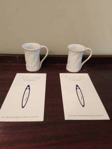 lot 144 image: Two Porcelain Whale Mugs by Robin Berry (UMN Alumni Artist) & Postcard