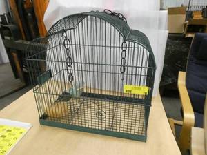 Metal bird cage with a metal bird and nest inside