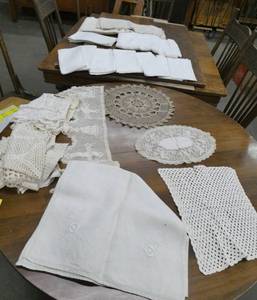 Large group of crochet and linens.  Much of the handiwork has stains and yellowing but the set of 12 linen napkins are in good shape as well as the tablecloth