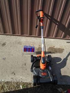 Black & Decker 20 vot litium ion weed trimmerlawn mower. Looks new. Inlcudes battery & charger. Tested & works. As shown.
