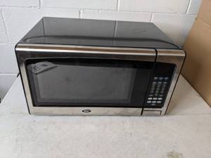 lot 227 image: Oster 1.1 Cu. Ft. 1000-Watt Countertop Microwave Oven with Stainless Steel Front
