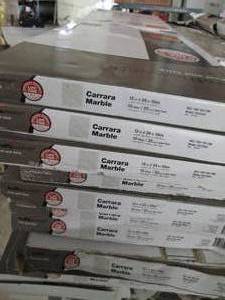 lot 5 image: 18 cases of Carrara Marble 12 in. x...
