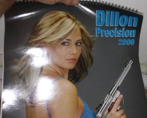 lot 40 image: Posters - female model theme furs and firearms.