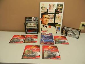 lot 32 image: GREAT COLLECTION - 007 JAMES BOND - TIN DISPLAY SIGN, 164 SCALE CARS, 143 SCALE CARS, GAME, - ALL NEW IN BOX - SEE PICTURES