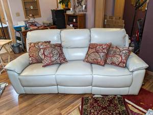 lot 29 image: Cream Colored Adjustable Reclining Sofa with USB Chargers & Floor Pillows