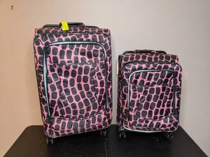 lot 34 image: Lot of Two Pink and Black, Animal Print, Rolling Suitcases