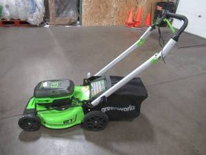lot 7 image: Greenworks 48V 21-inch Self-Propelled Walk-Behind Lawn Mower W(4) 4 Ah Batteries - MISSING CHARGERS, BROKEN HANDLE - RUNS