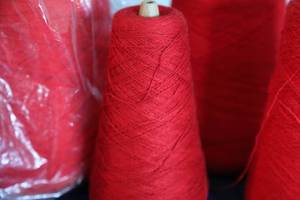 lot 36 image: Five Skeins Of Bright Red Or Bright Orange Yarn