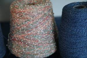 lot 37 image: Three Skeins Of Blues & Variegated Tan & Multicolored Yarn