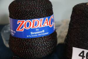 lot 46 image: Zodiac By Bramwell  (91% Acrylic--9% Polyester) --Two Skeins In Black--One Skein In Red