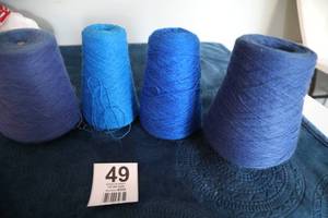 lot 49 image: Four Skeins Of Blue Yarn