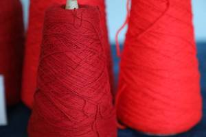 lot 62 image: Four Skeins Of Red Yarn
