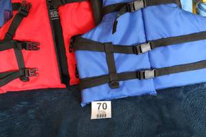 lot 70 image: Life Jackets (Adult)--One Red & One Blue--(Sea Choice)---One Blue (Stearns) Life Jacket--Two Young Adult Life Jackets--Light Blue & Yellow--Stearns--One Red & Grey
