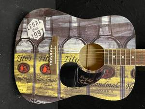 lot 46 image: Titos Handmade Vodka accoustic guitar, autographed by Tito