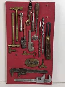 lot 6 image: Very Rare VintageTools and Rare Brass Coors Emblem Sample Display-Silver Thunderbird, Brass Radiator Keys, Monkey Wrenches, Brass Jewelers Hammers, ANd More