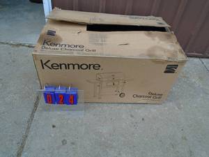 Kenmore deluxe charcoal grill. Appears new in box. Completeness unknown. As shown.