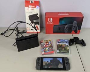 lot 299 image: Nintendo Switch w Super Marios Odyssey, Minecraft Bundle, & Starter Kit Pro