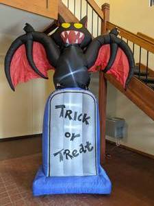 lot 44 image: Creepy 10-Ft. Halloween Inflatable Bat on a Tombstone with Lights - Fraser Hill Farm