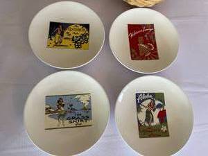 lot 209 image: Four Pottery Barn Hawaiian Themed Plates in Wicker Case