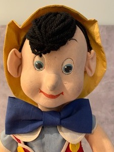 lot 23 image: Linen Like Pinocchio 1939 Republished Book and Cloth Figurine
