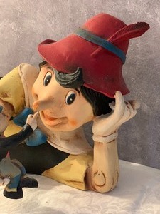 lot 24 image: Vintage Lounging Pinocchio and Jiminy Cricket Figurine