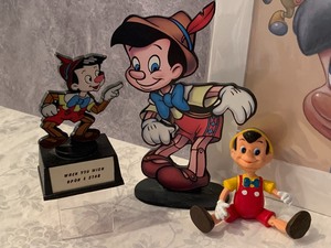 lot 22 image: Fun Variety of Collectible Pinocchio Figurines and Print