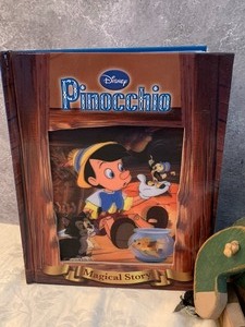 lot 37 image: Wooden Pinocchio Figurine and Pinocchio Book