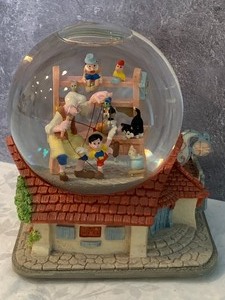 lot 96 image: Musical Pinocchio Snowglobe
