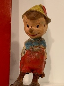 lot 154 image: Vintage Pinocchio Figurine and Vintage Pinocchio Book