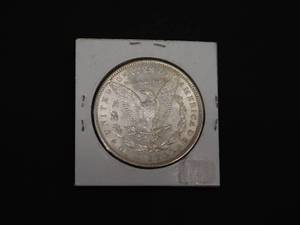 lot 31 image: 1886 BU Morgan Silver Dollar  Marked MS65 when purchased