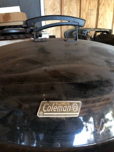 lot 41 image: Coleman Rolling Metal Fire Pit