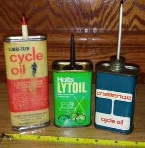 lot 122 image: (3) Cycle Oil Cans, Lubri-Tech, Holts, And Elf-All Empty.