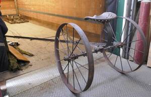 Large antique wheels and seat, this is about 12 ft long and 3-12 ft tall