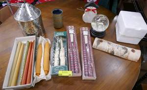 Group of candles, candle holders and a reindeer snow globe