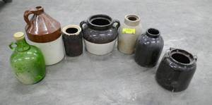 Group of pottery jugs and one glass one