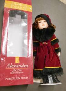 New Porcelain doll on stand with a velvety Christmas dress, limited edition